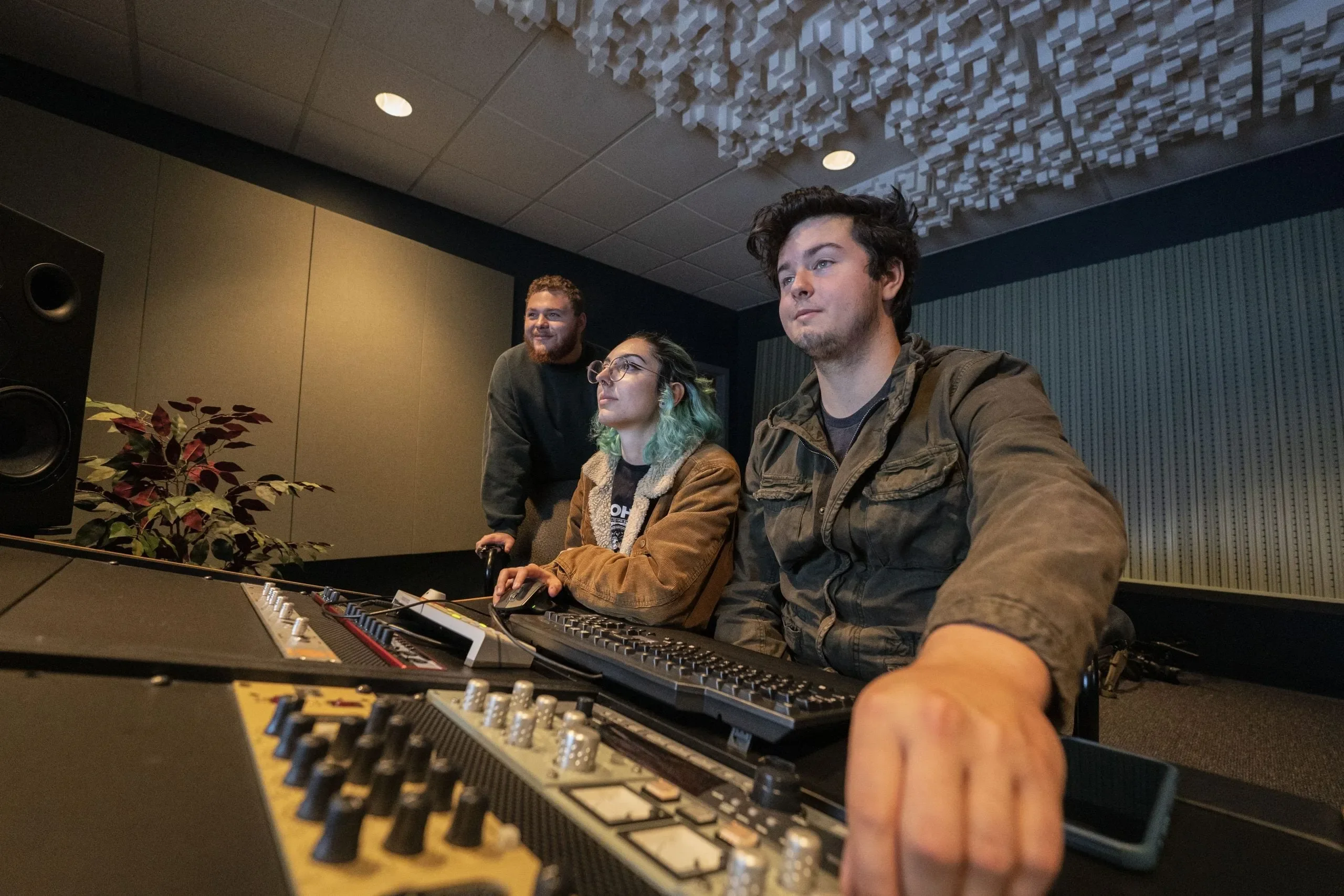 Audio music production students work in studio