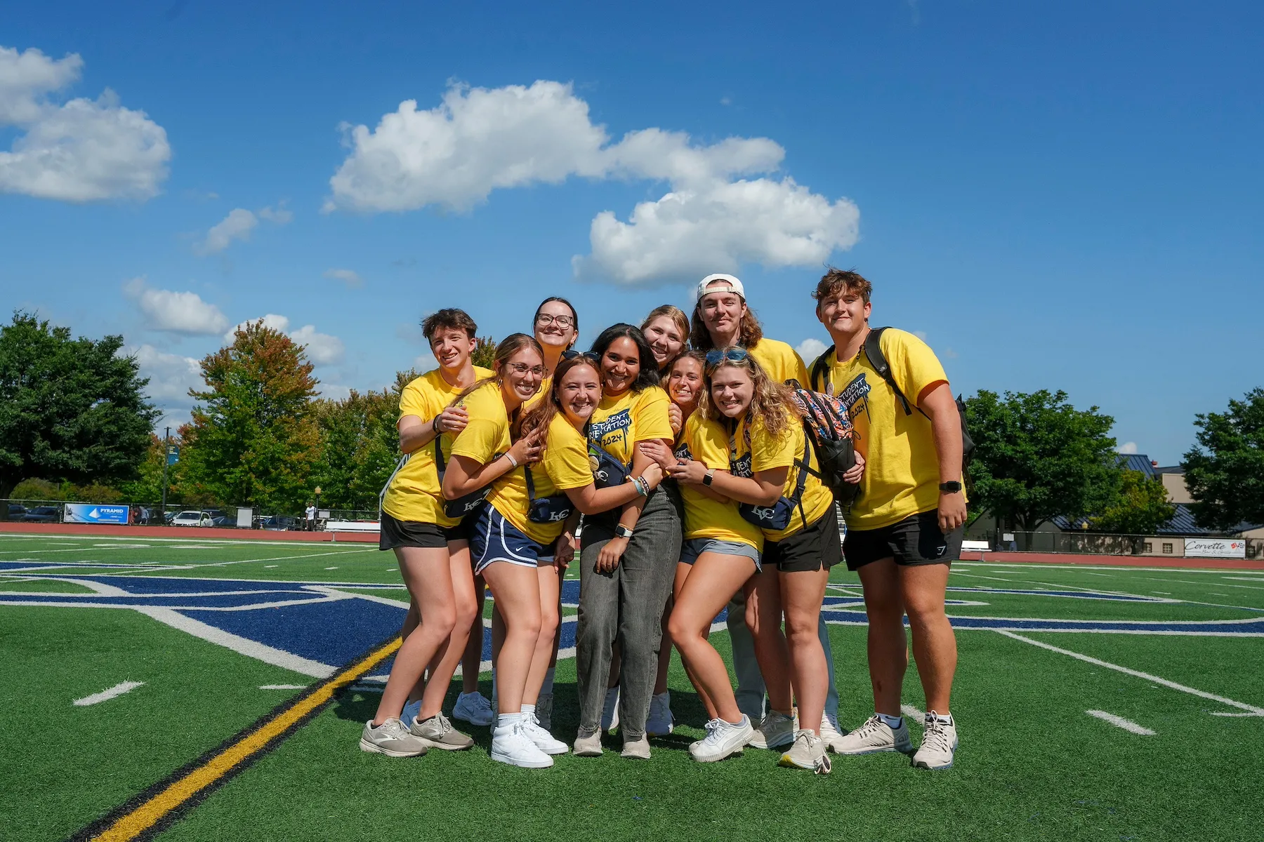 First Year Mentors pose on football field during new student orientation