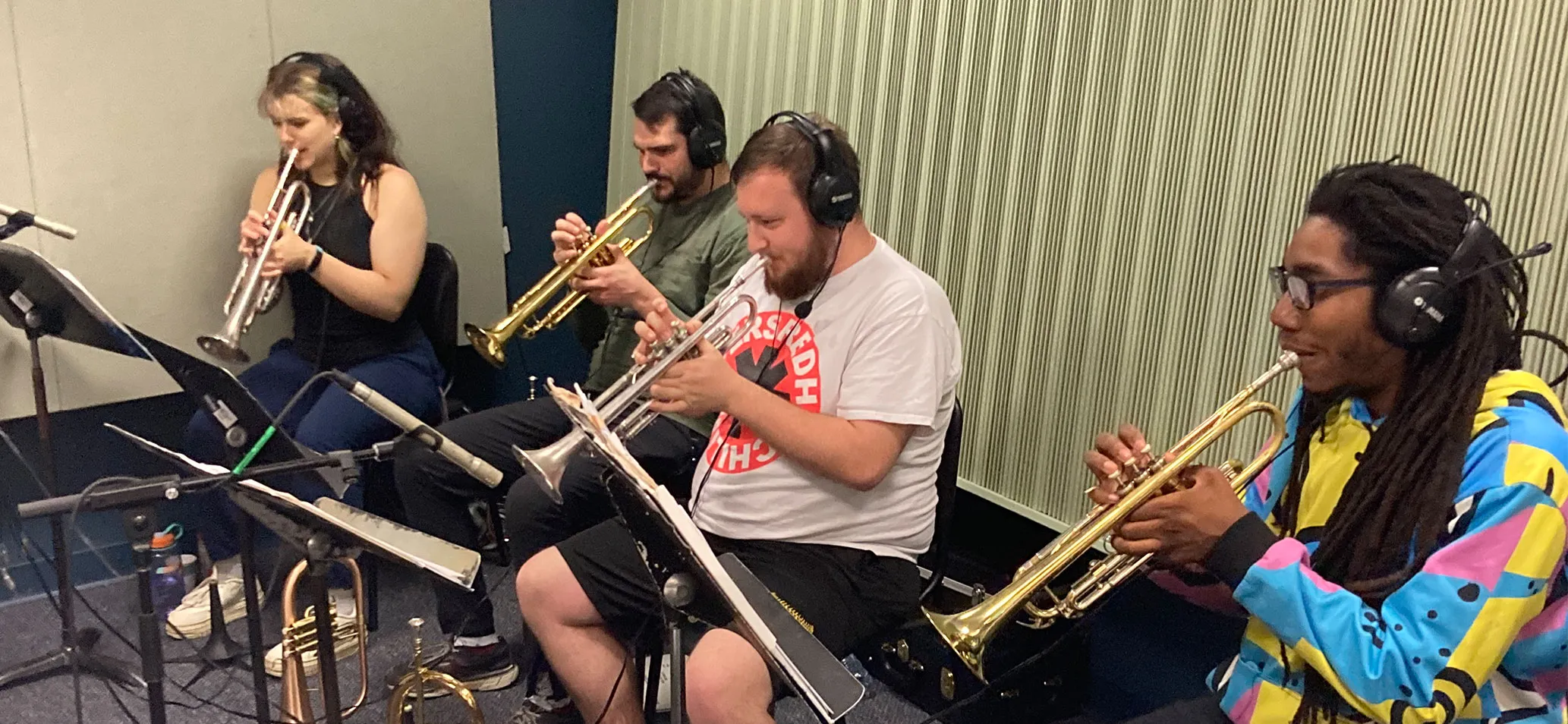 Students play trumpet during jazz album recording