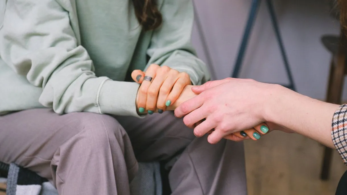 People hold hands in show of support