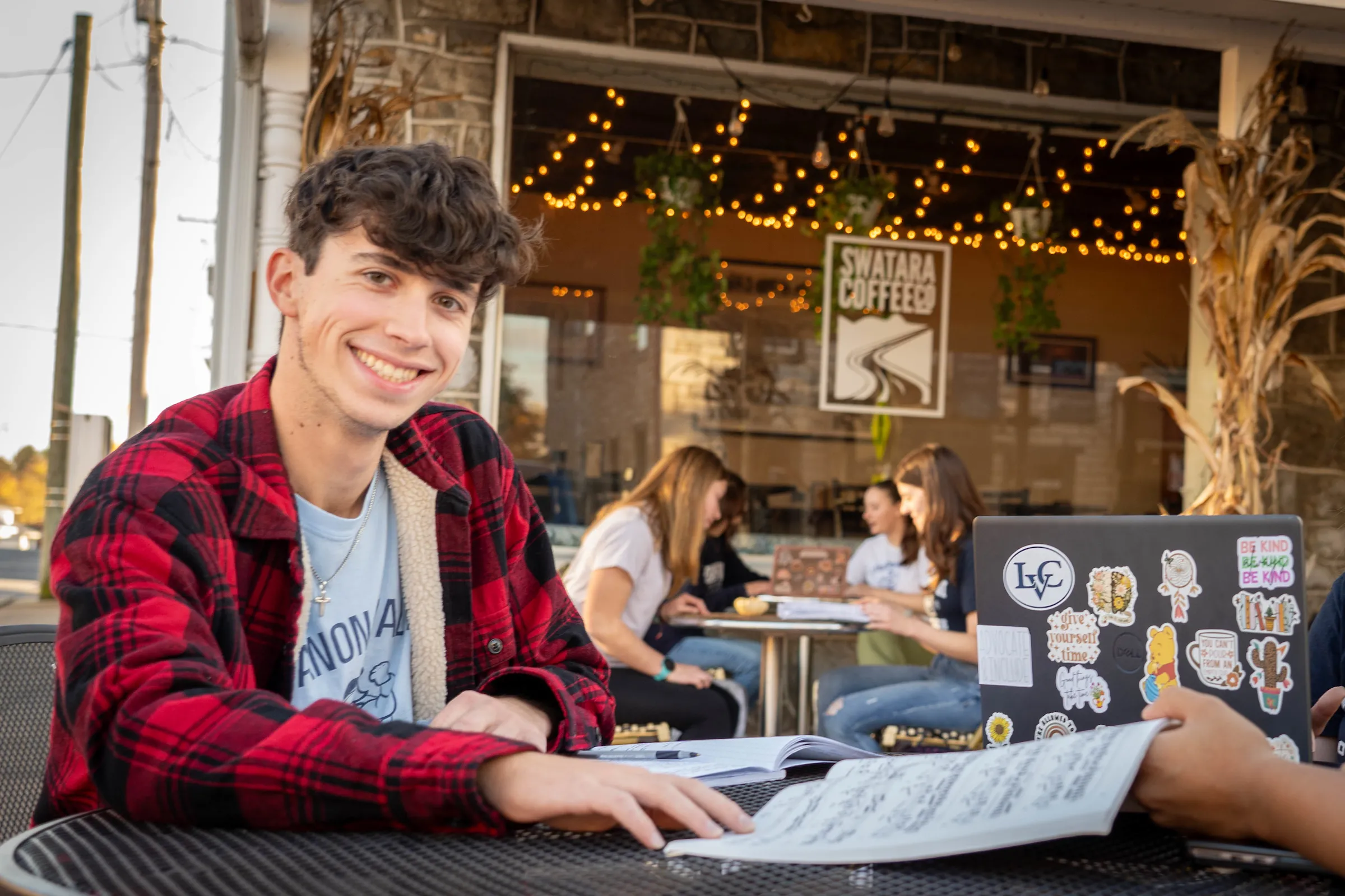 Alex Beagle sits at table outside coffee shop on Main Street in Annville