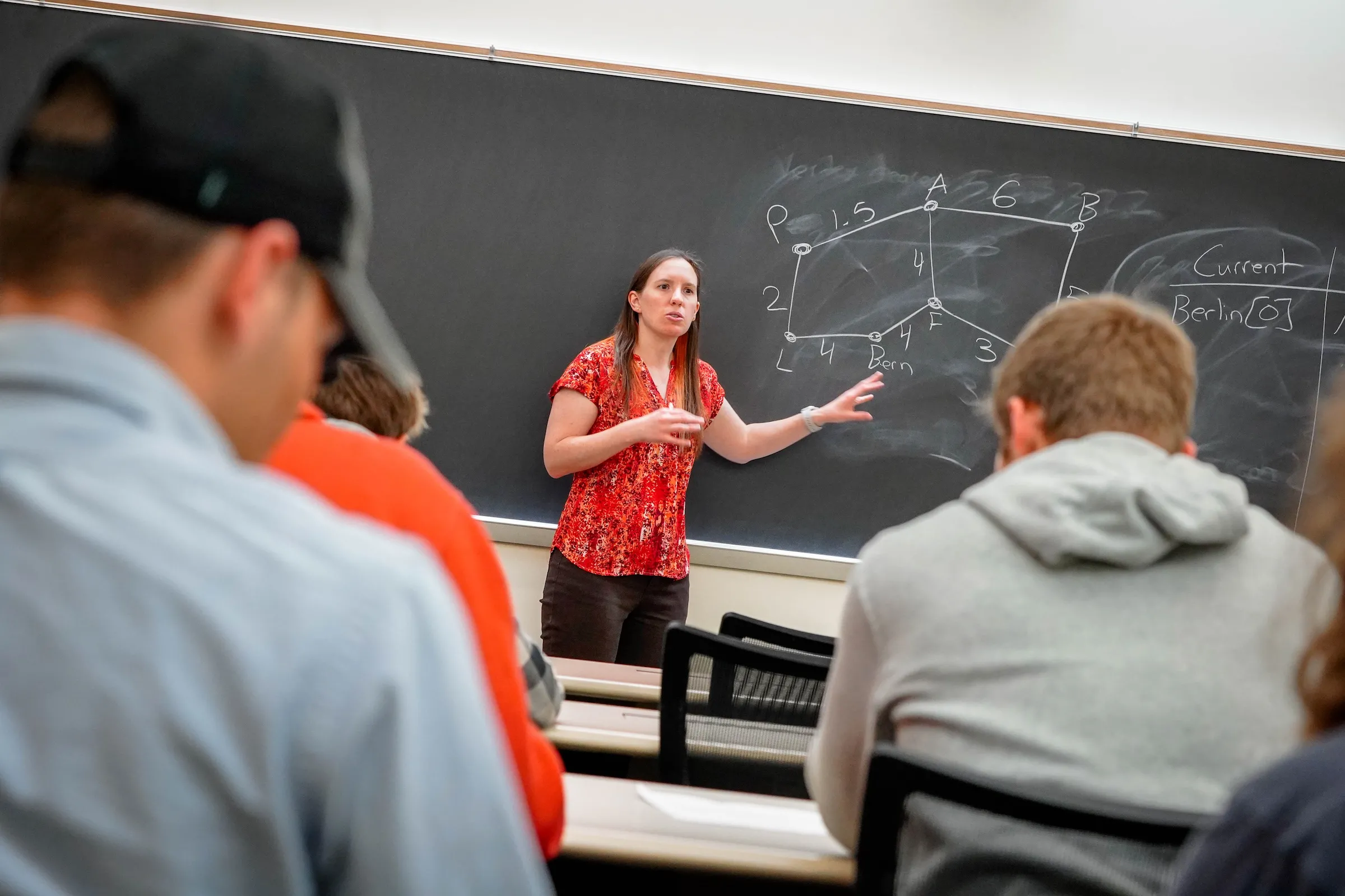 Dr. Stephanie Blanda teaching at front of classroom